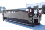Rumpke Commercial Roll Off Dumpster At Local Tire Shop