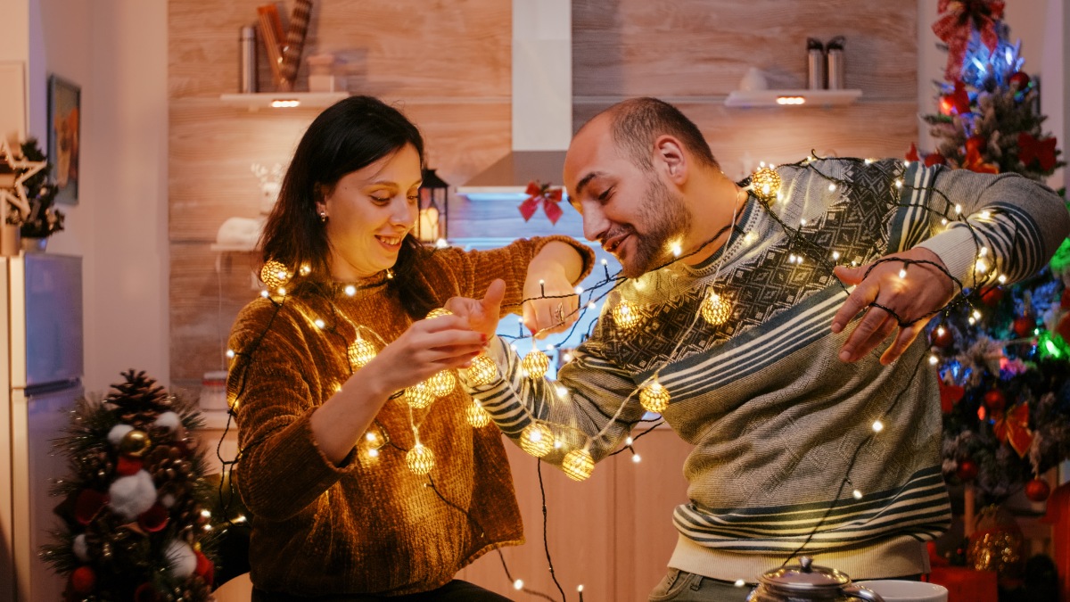 A Couple Reusing Two Sets Of Old Christmas Lights