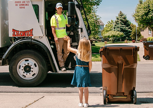 Rumpke Truck Driver Greeting Little Girl At Trash Pickup