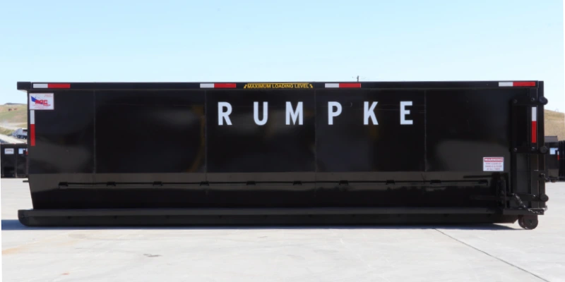 Black Rumpke Roll Off Dumpster On Concrete Pad
